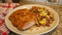 Knuspriges Schnitzel mit Bratkartoffeln – so gelingt die goldbraune Panade